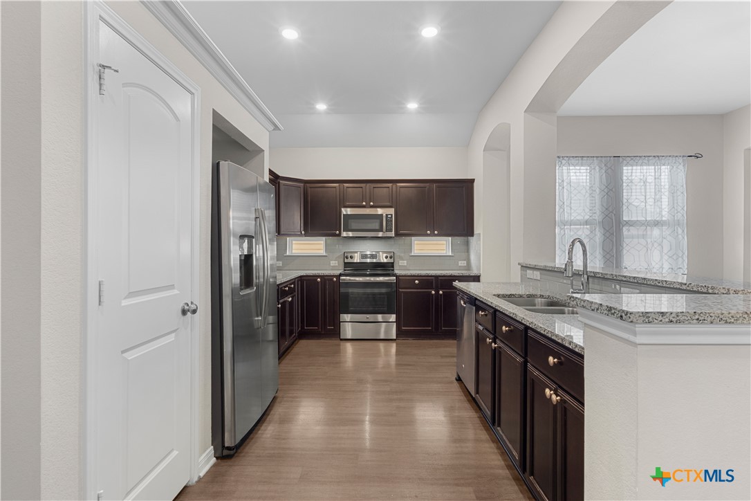 3615 Addison Street Killeen, TX 76542 - Photo 10 of 47 a large kitchen with stainless steel appliances a sink and cabinets