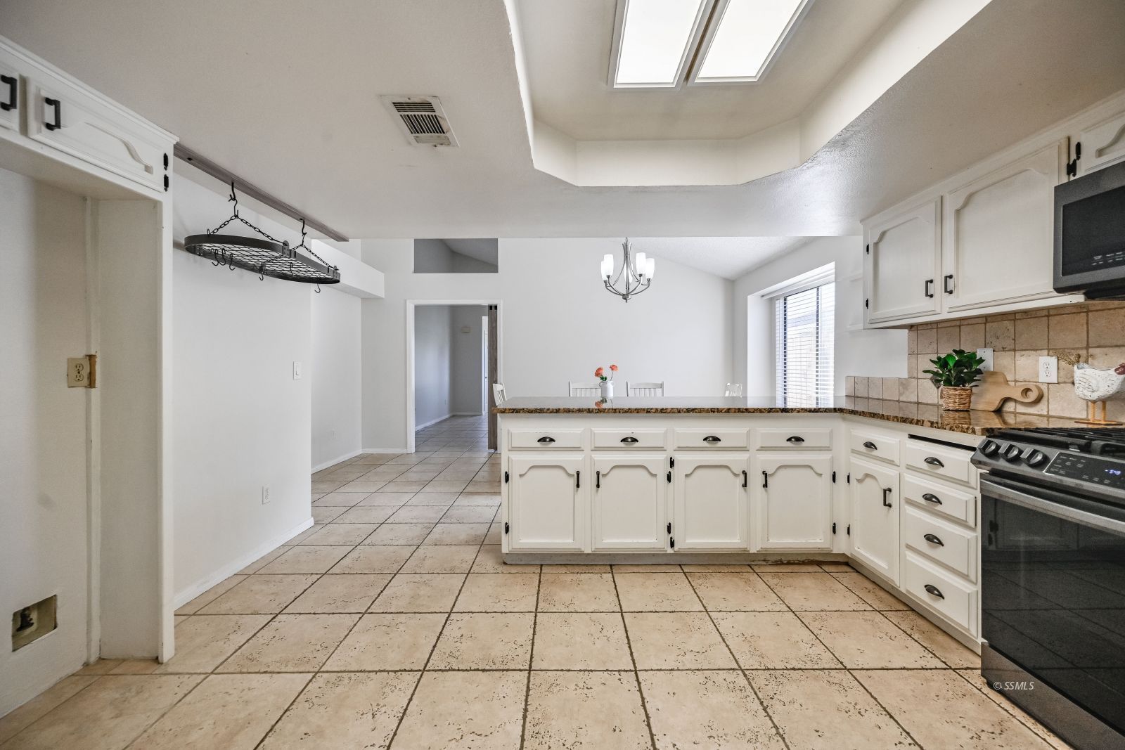 815 Walker Lane Ridgecrest, CA 93555 - Photo 3 of 23 a kitchen with stainless steel appliances granite countertop a stove a sink and a refrigerator