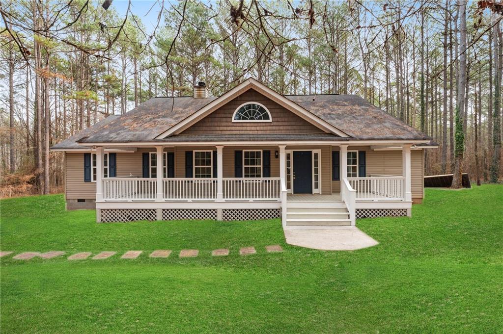 a front view of a house with a garden and porch