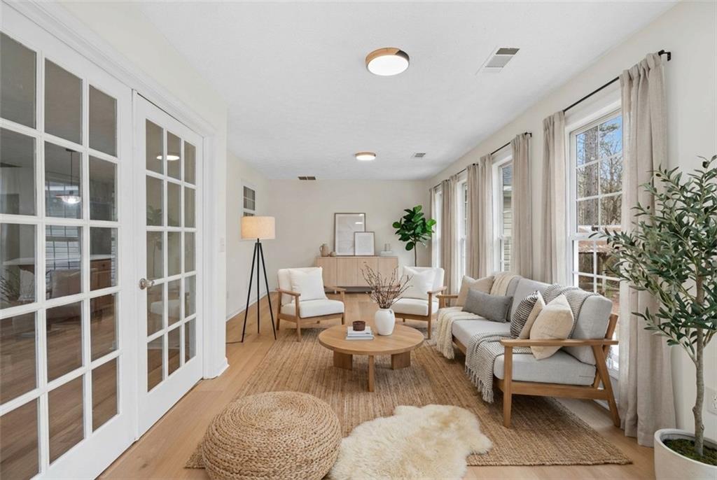1227 Al Roberts Road Senoia, GA 30276 - Photo 13 of 43 a living room with furniture a lamp and a potted plant