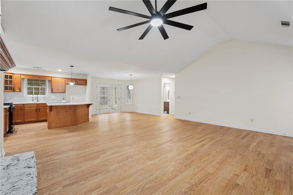 1227 Al Roberts Road Senoia, GA 30276 - Photo 18 of 43 an empty room with wooden floor and windows