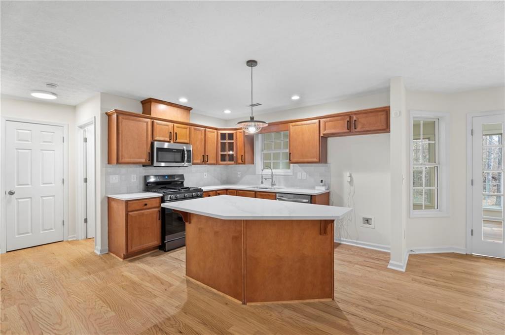 1227 Al Roberts Road Senoia, GA 30276 - Photo 20 of 43 a kitchen with stainless steel appliances granite countertop a sink stove and refrigerator