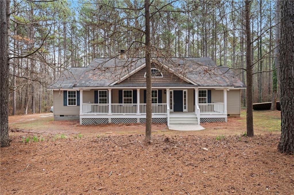 1227 Al Roberts Road Senoia, GA 30276 - Photo 2 of 43 a front view of a house with a garden