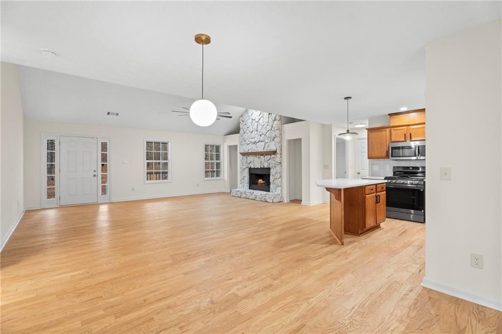 1227 Al Roberts Road Senoia, GA 30276 - Photo 22 of 43 a view of a kitchen with a stove cabinets and wooden floor