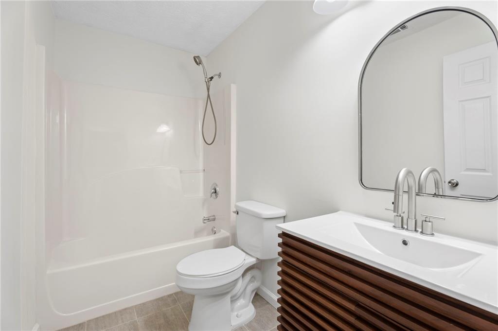 1227 Al Roberts Road Senoia, GA 30276 - Photo 25 of 43 a bathroom with a sink a toilet and a mirror