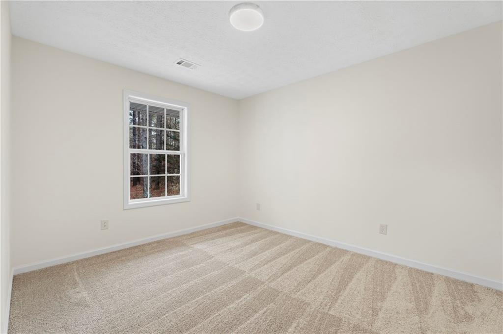 1227 Al Roberts Road Senoia, GA 30276 - Photo 26 of 43 an empty room with a window