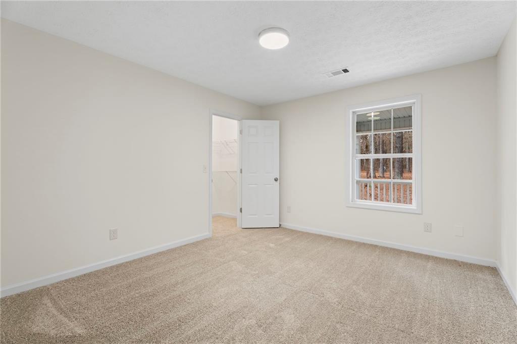 1227 Al Roberts Road Senoia, GA 30276 - Photo 28 of 43 an empty room with windows