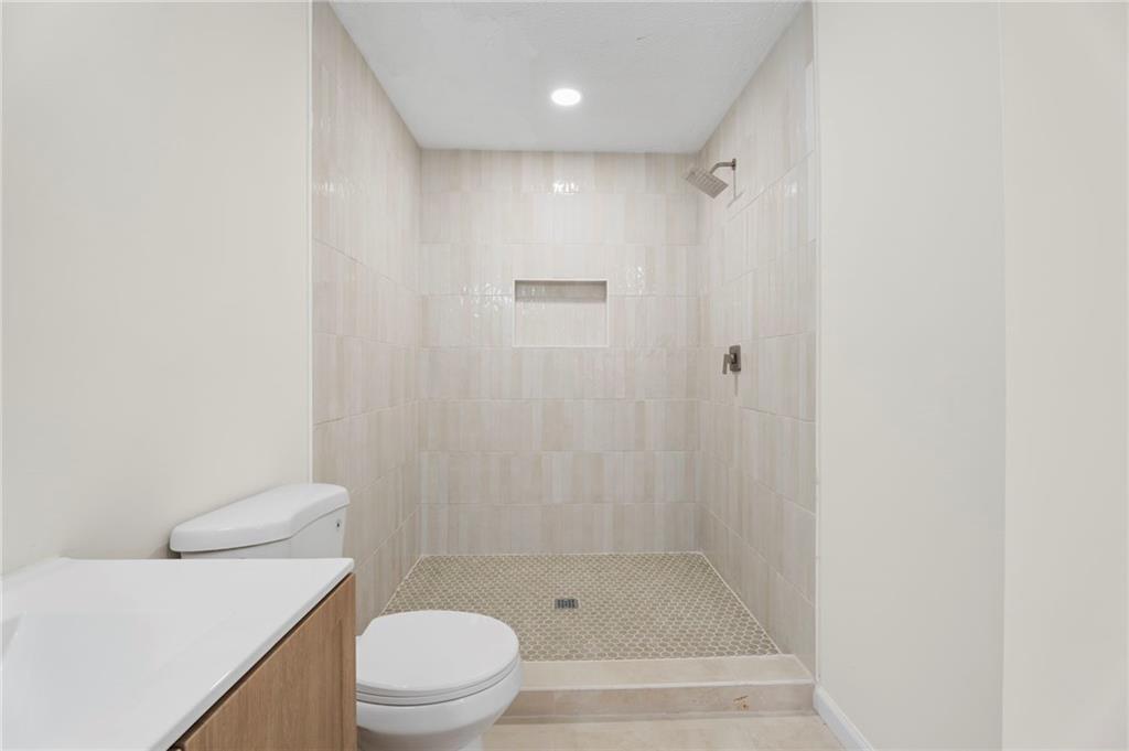 1227 Al Roberts Road Senoia, GA 30276 - Photo 33 of 43 a bathroom with a shower a toilet and sink