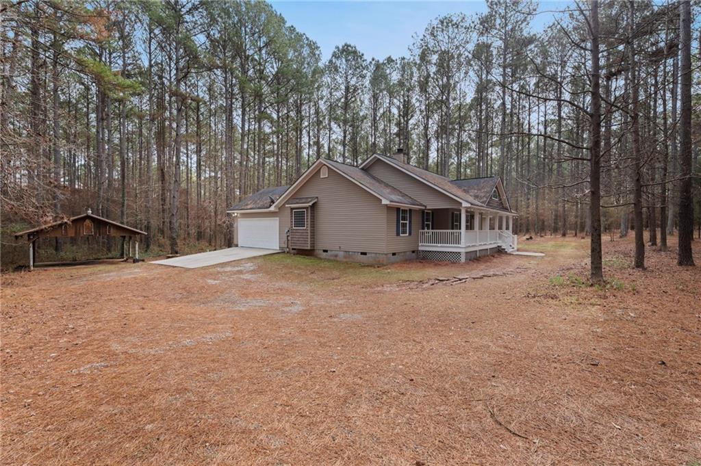 1227 Al Roberts Road Senoia, GA 30276 - Photo 41 of 43 a house with trees in the background