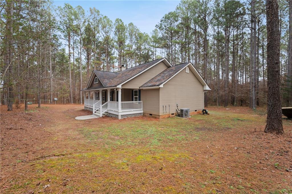 1227 Al Roberts Road Senoia, GA 30276 - Photo 42 of 43 a view of a house with backyard and trees