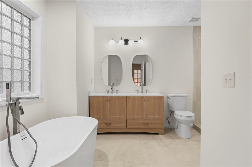 1227 Al Roberts Road Senoia, GA 30276 - Photo 10 of 43 a bathroom with a sink a toilet and mirror