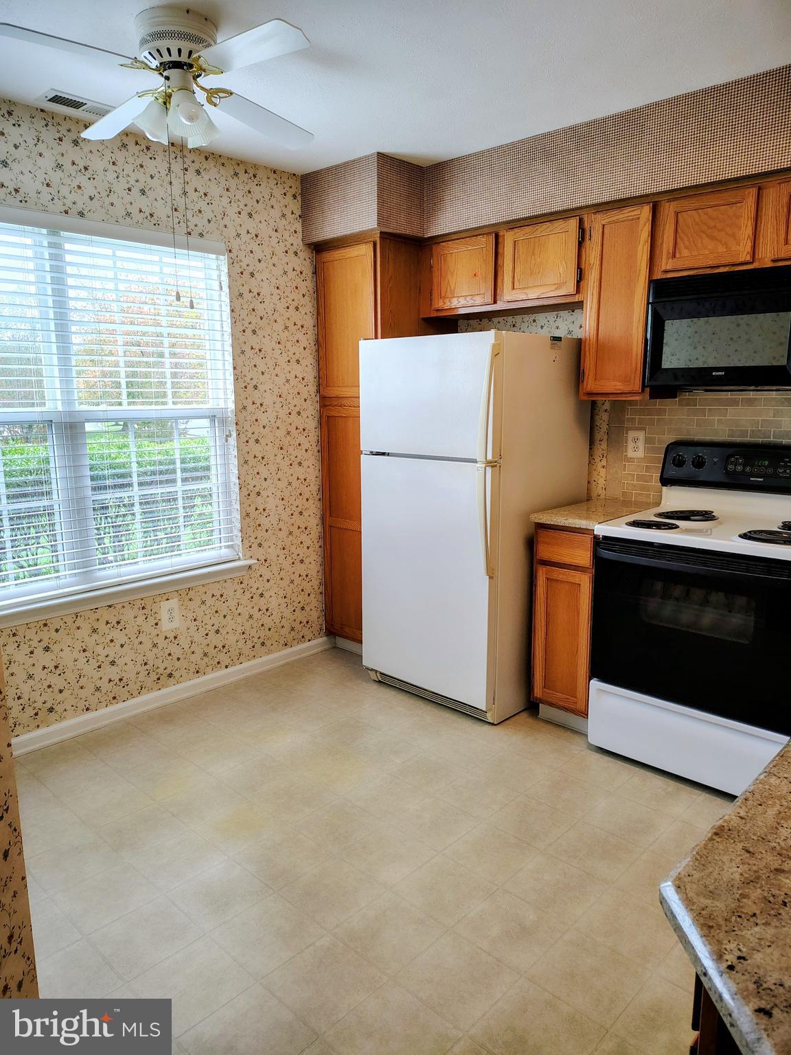 2803 Sweetleaf Terrace Mount Laurel, NJ 08054 - Photo 8 of 13 a kitchen with stainless steel appliances granite countertop a refrigerator a stove and a sink with wooden floor