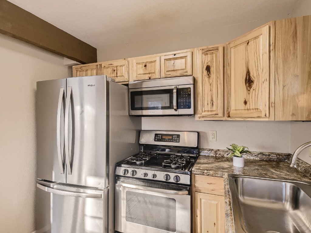 402 Alpine Road Dillon, CO 80435 - Photo 7 of 21 a kitchen with stainless steel appliances granite countertop a refrigerator stove and sink