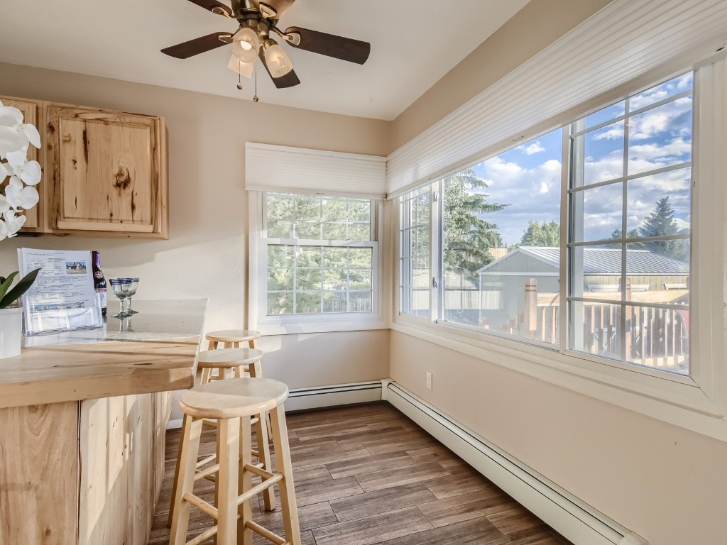 402 Alpine Road Dillon, CO 80435 - Photo 8 of 21 a dining room with wooden floor a chandelier fan a wooden table and chairs