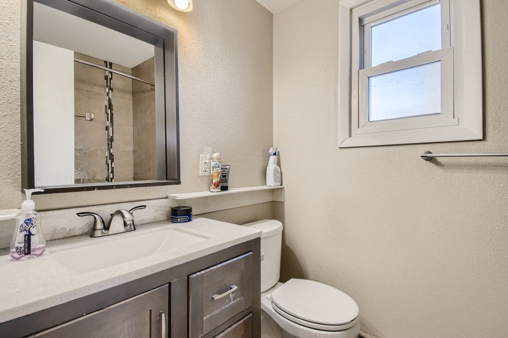 402 Alpine Road Dillon, CO 80435 - Photo 10 of 21 a bathroom with a granite countertop sink mirror vanity and toilet