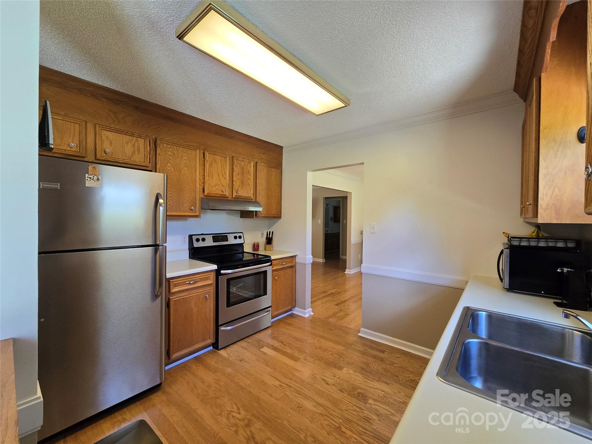 5238 Bethel Church Road Hickory, NC 28602 - Photo 11 of 22 a kitchen with stainless steel appliances granite countertop a refrigerator a stove a sink and a microwave