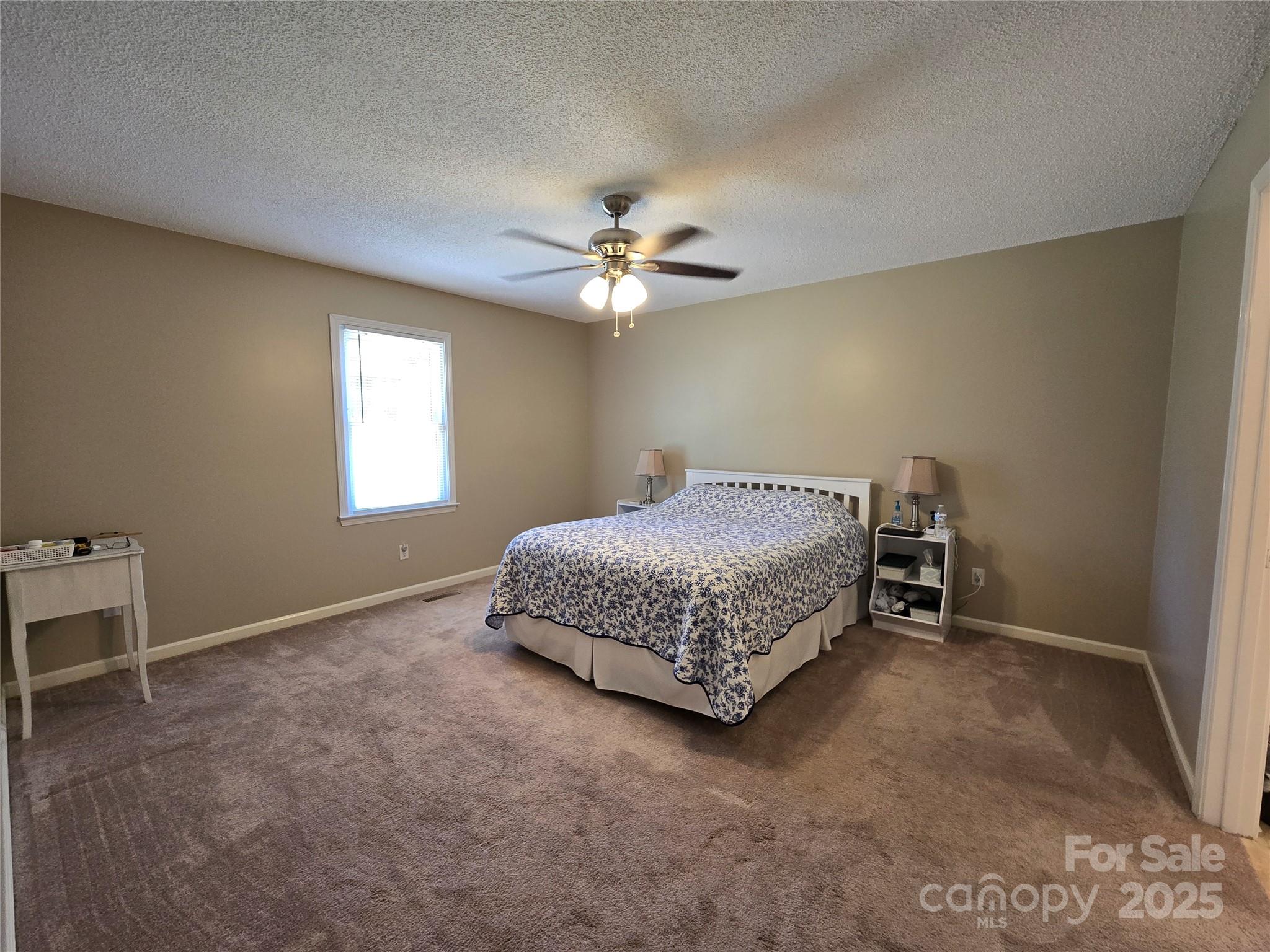 5238 Bethel Church Road Hickory, NC 28602 - Photo 15 of 22 a bedroom with a bed and a ceiling fan