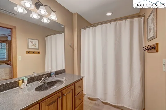 a bathroom with a double vanity sink and a mirror