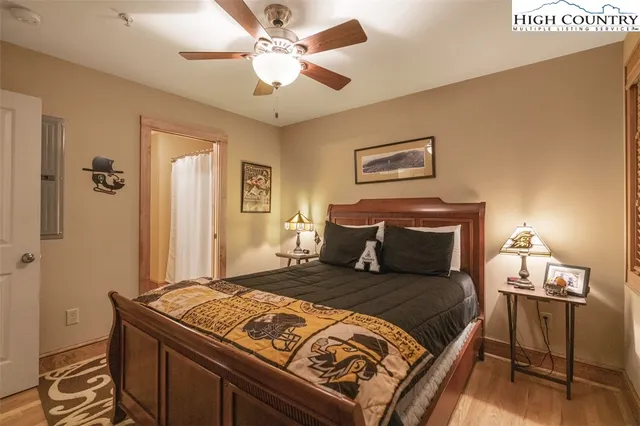 a bedroom with a bed and a chandelier