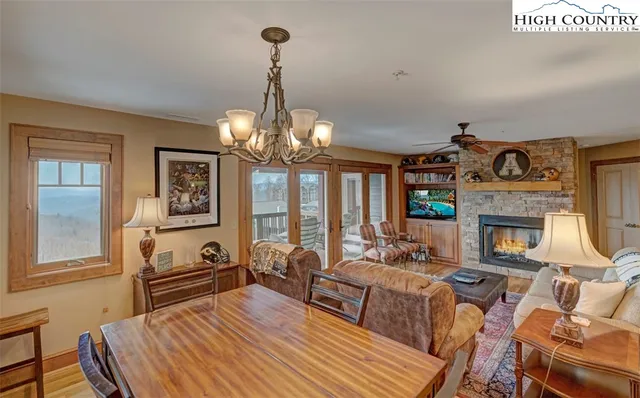 a view of a livingroom with furniture a chandelier and wooden floor