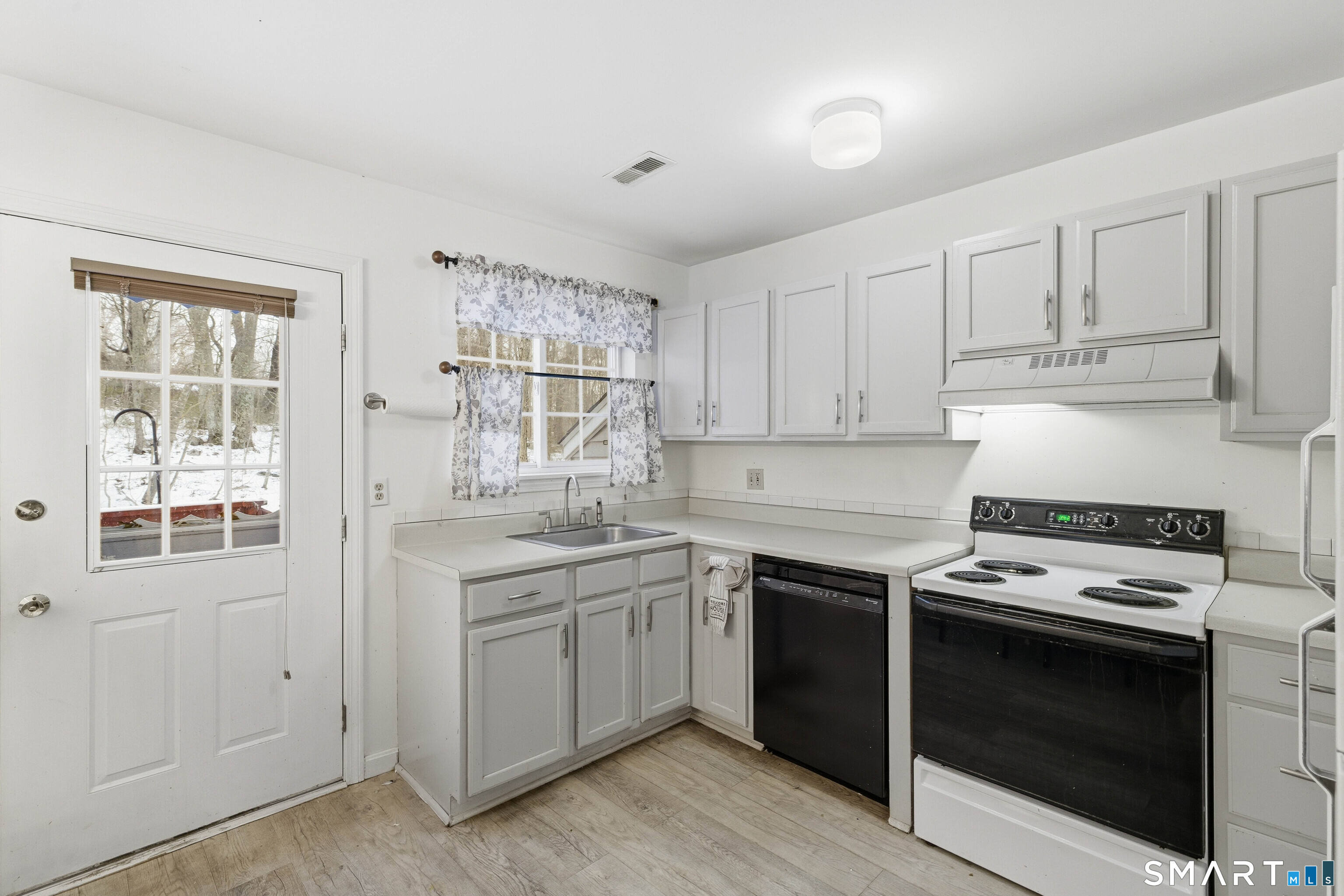 310 Boston Post Road, Unit 76 Waterford, CT 06385 - Photo 14 of 40 a kitchen with a stove sink and cabinets