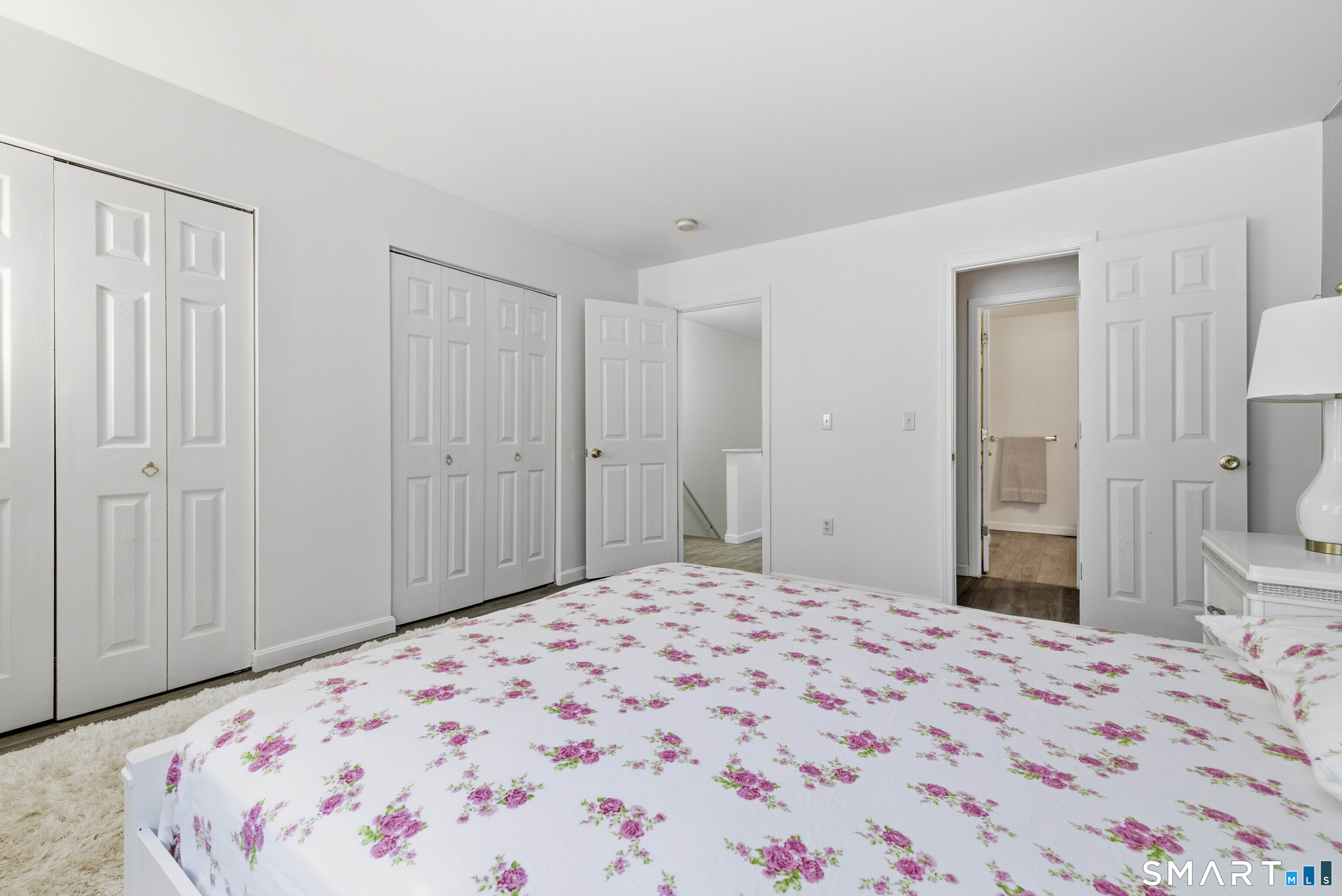 310 Boston Post Road, Unit 76 Waterford, CT 06385 - Photo 23 of 40 a bedroom with a bed and a lamp on dresser