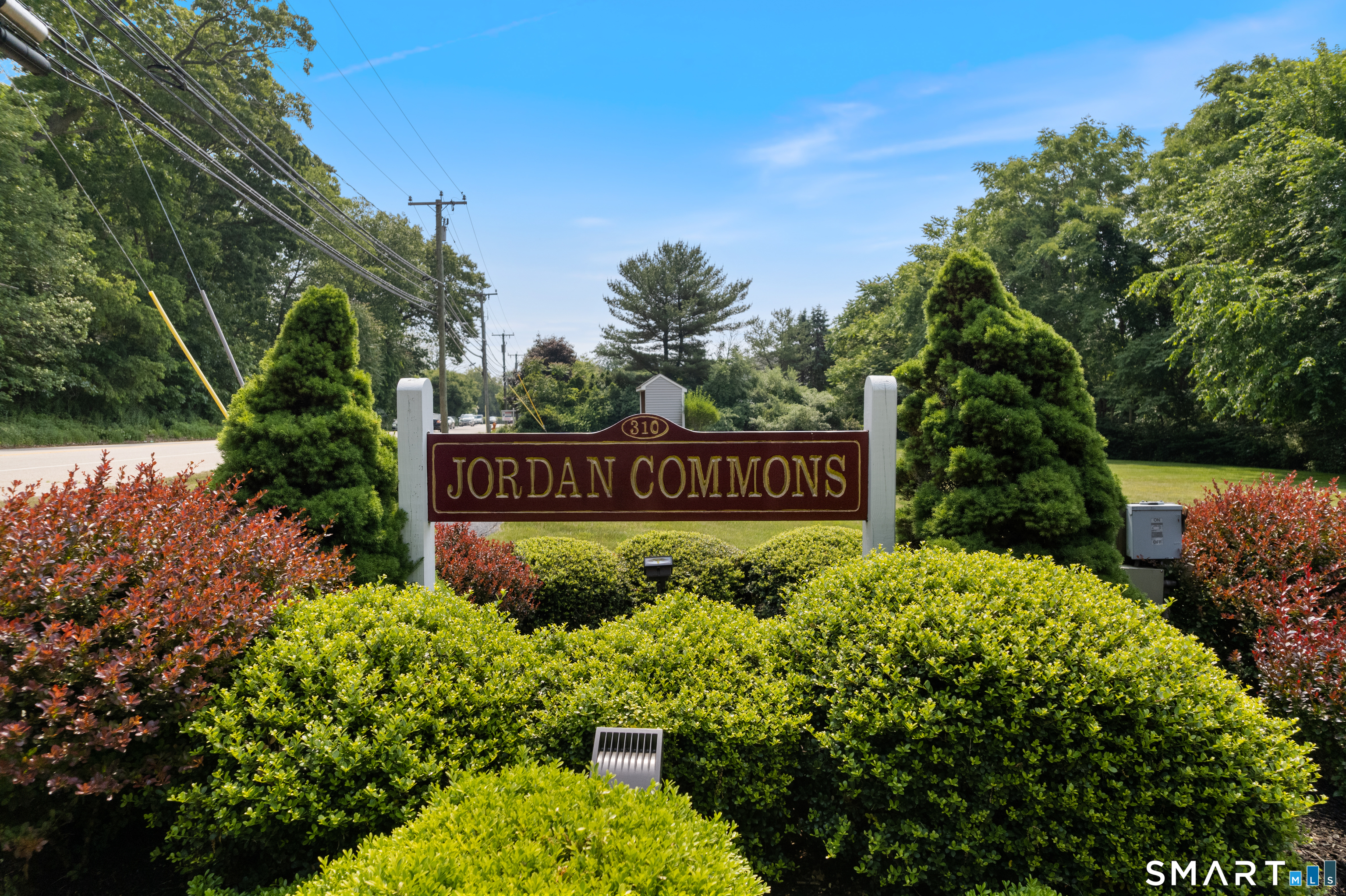310 Boston Post Road, Unit 76 Waterford, CT 06385 - Photo 36 of 40 a sign that is sitting in front of flowers