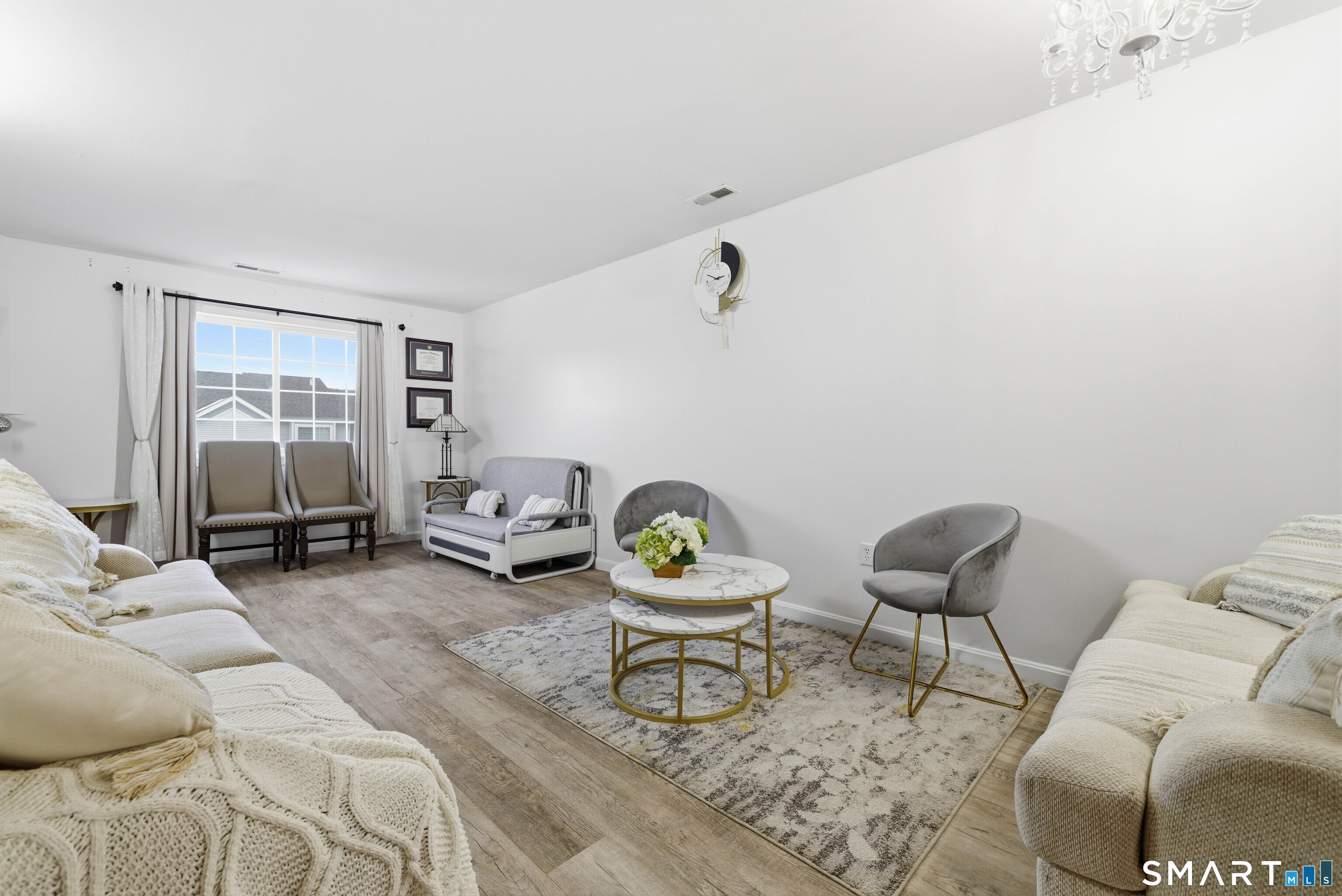 310 Boston Post Road, Unit 76 Waterford, CT 06385 - Photo 6 of 40 a living room with furniture and a lamp