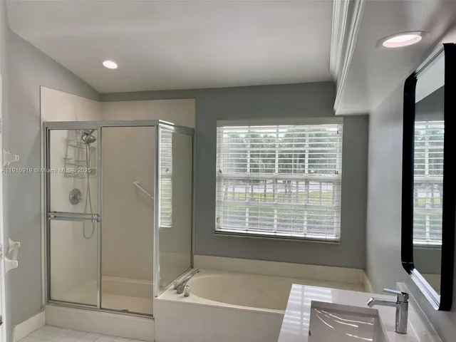 a bathroom with a bathtub and a shower