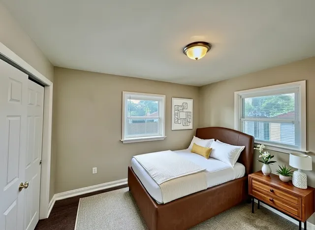 a bedroom with a bed and window