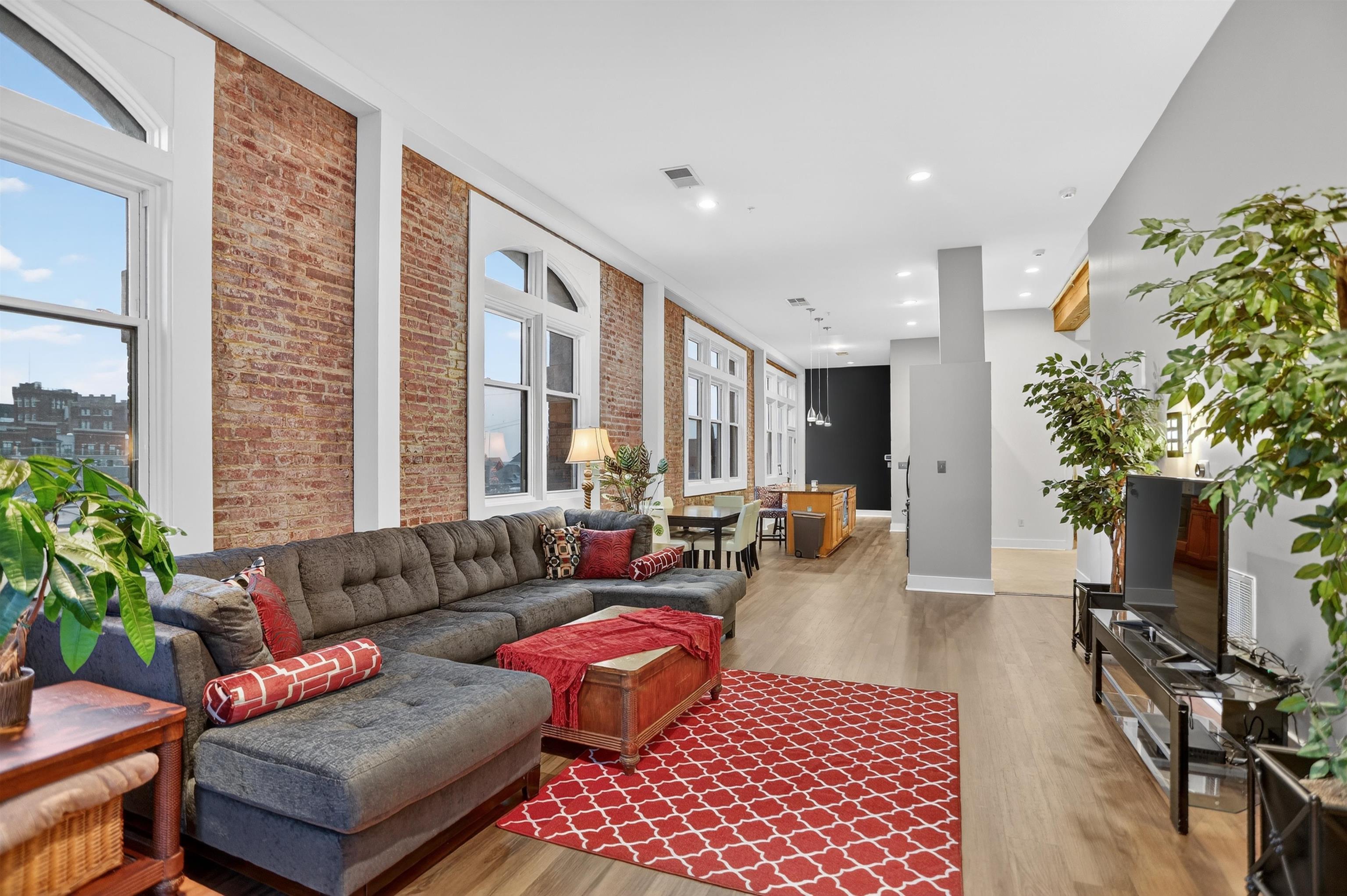 435 South Front Street, Unit 307 Memphis, TN 38103 - Photo 11 of 40 a living room with furniture and a potted plant