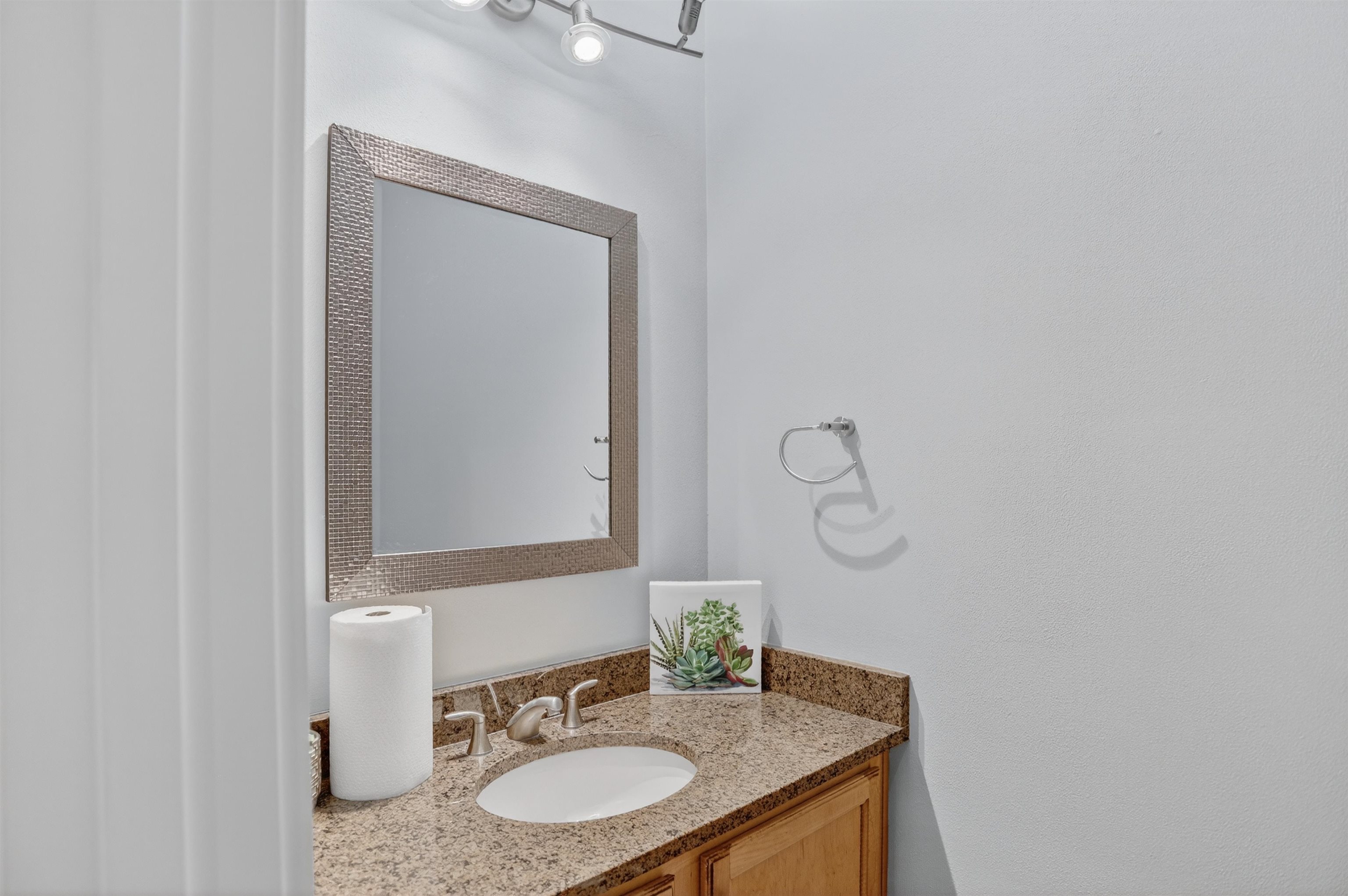 435 South Front Street, Unit 307 Memphis, TN 38103 - Photo 26 of 40 a bathroom with a granite countertop sink and a mirror