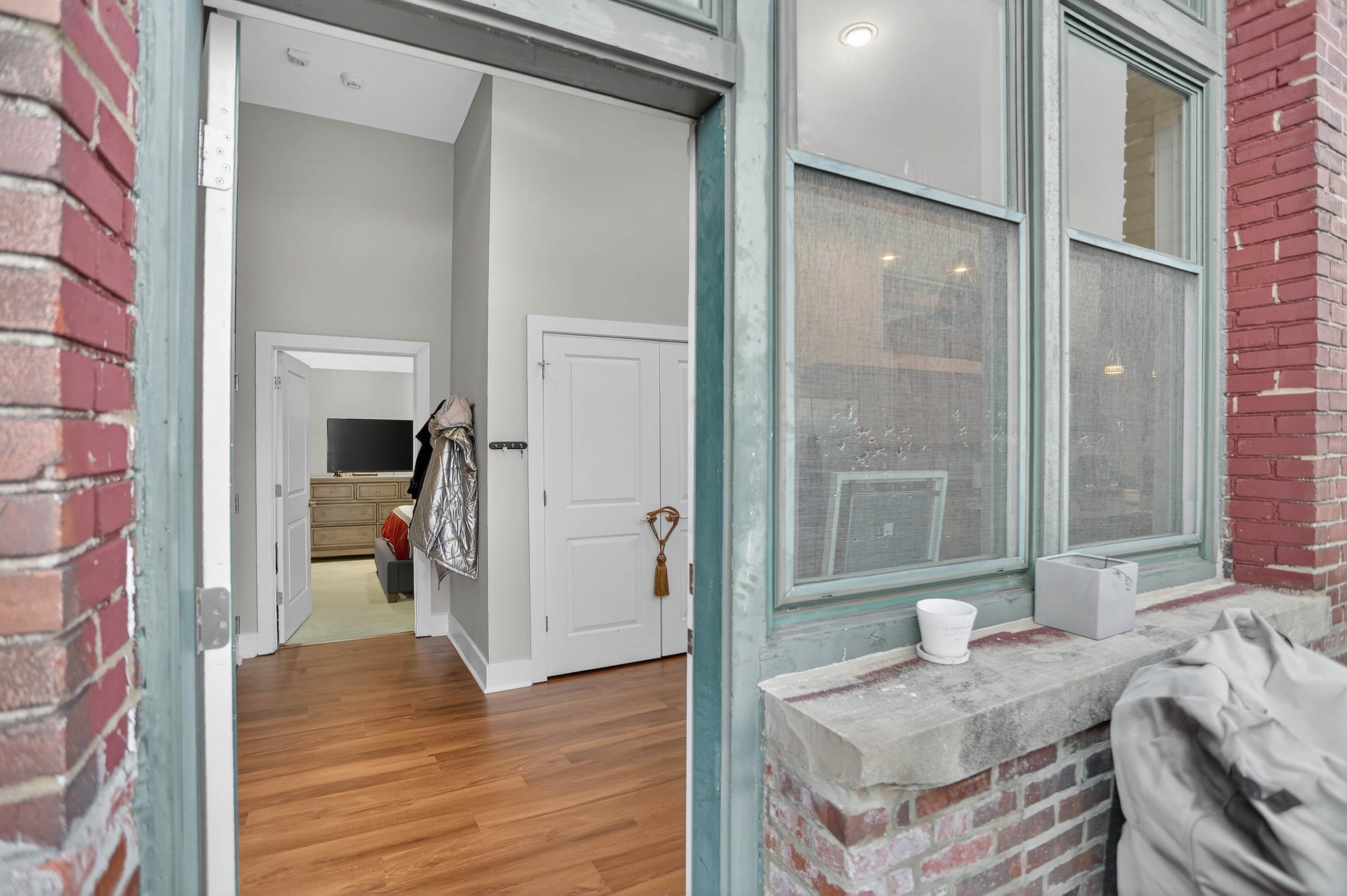 435 South Front Street, Unit 307 Memphis, TN 38103 - Photo 33 of 40 a bathroom with a granite countertop sink and a mirror