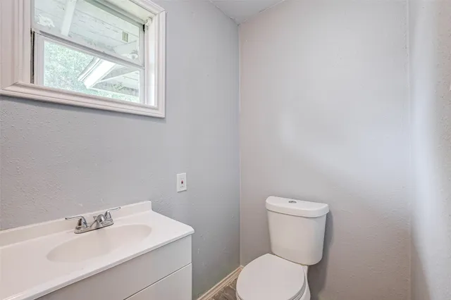 a white toilet sitting next to a bathroom sink