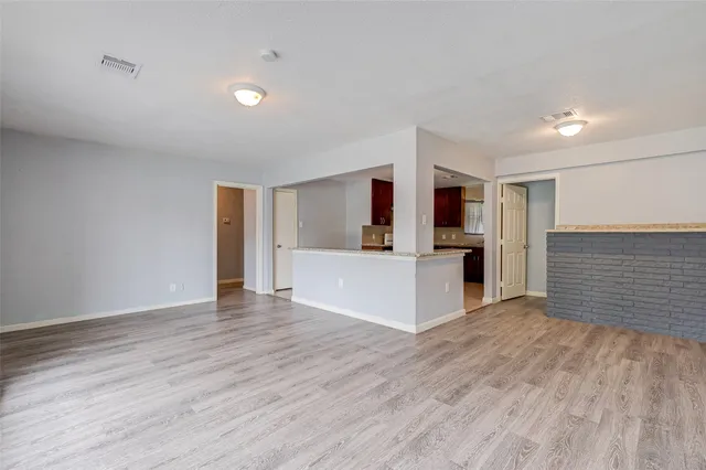 a view of a kitchen with wooden floor