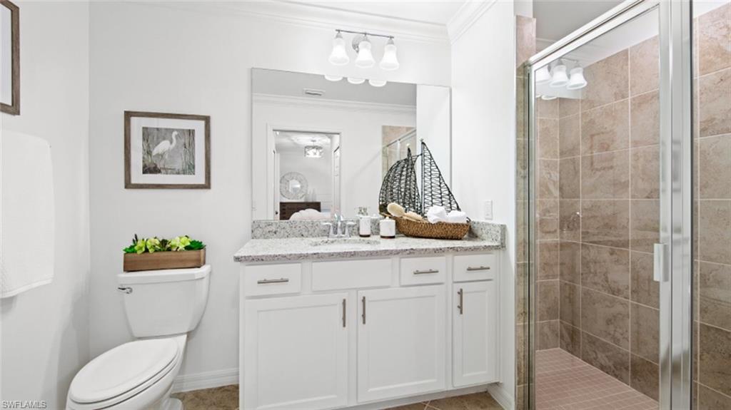 5491 Double Eagle Circle, Unit 3723 Ave Maria, FL 34142 - Photo 14 of 42 Ensuite bathroom with ornamental molding, a shower stall, vanity, and light tile patterned flooring