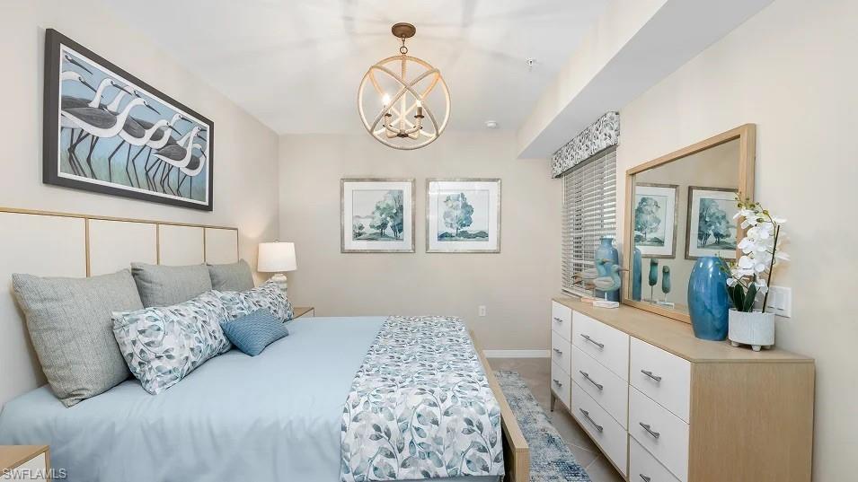 5491 Double Eagle Circle, Unit 3723 Ave Maria, FL 34142 - Photo 6 of 42 Bedroom with a chandelier and baseboards