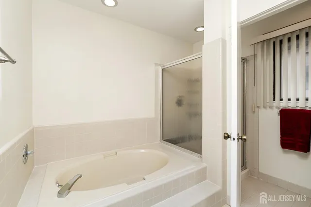 a bedroom with two beds and a large window