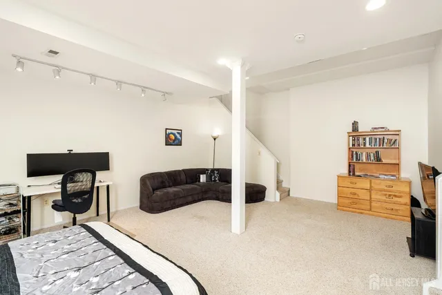 a living room with furniture and a ceiling fan