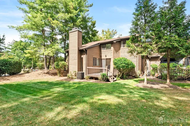 a view of a field with trees in the background