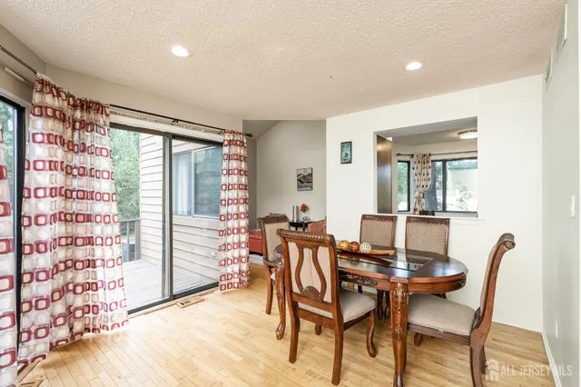 a view of a dining room with furniture and a window