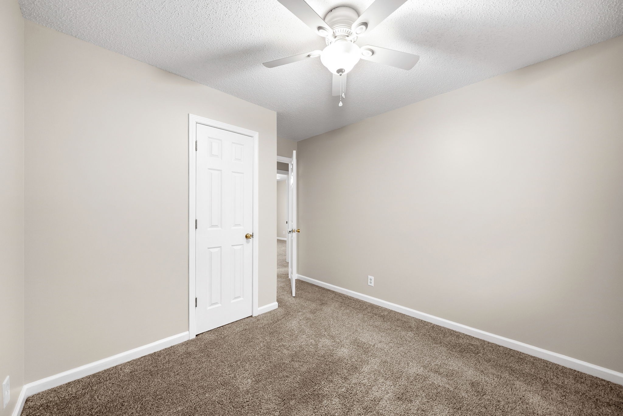 1957 Timberline Circle Oak Grove, KY 42262 - Photo 20 of 29 an empty room with a chandelier fan and a ceiling fan