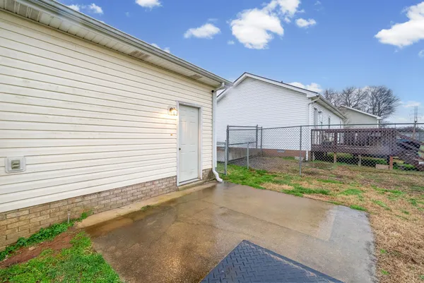 a view of a house with a yard and sitting area