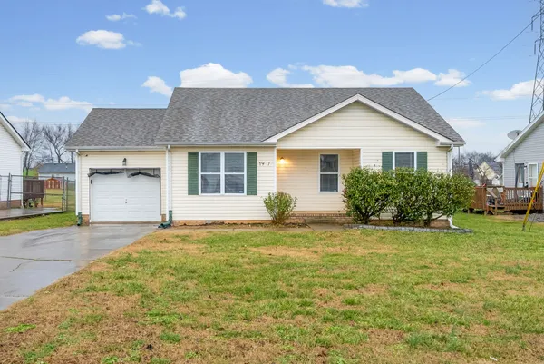 a view of a house with a yard and garage