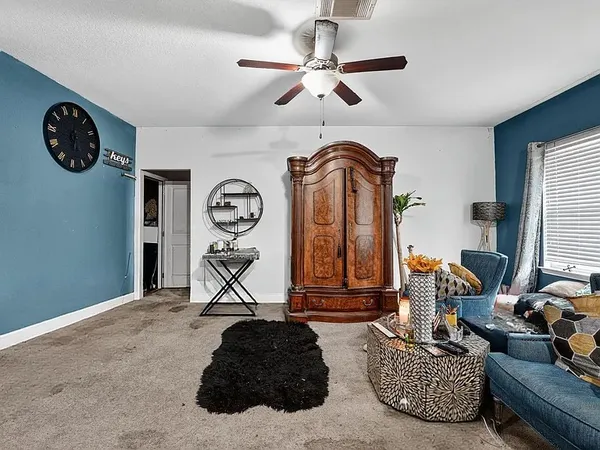 a living room with furniture a rug and a large window