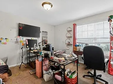 a view of a workspace with furniture and a fireplace