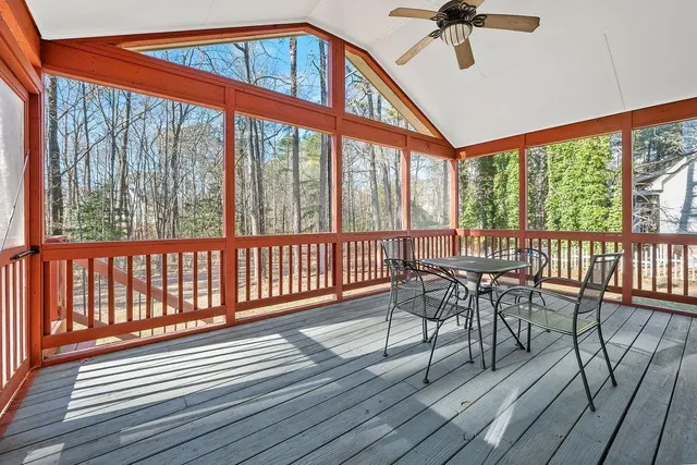 a view of a balcony with furniture and wooden floor