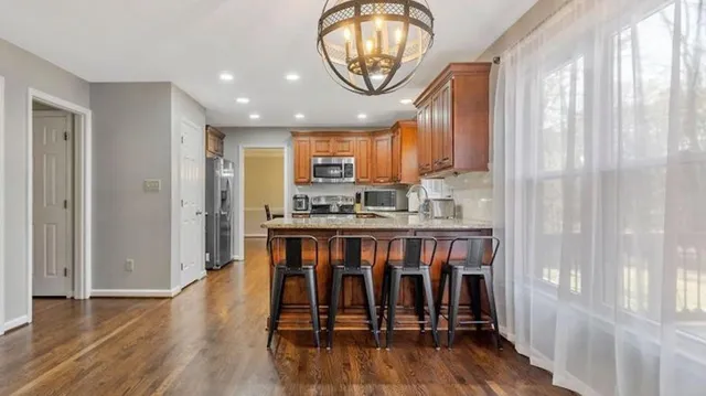 a view of kitchen with furniture and wooden floor