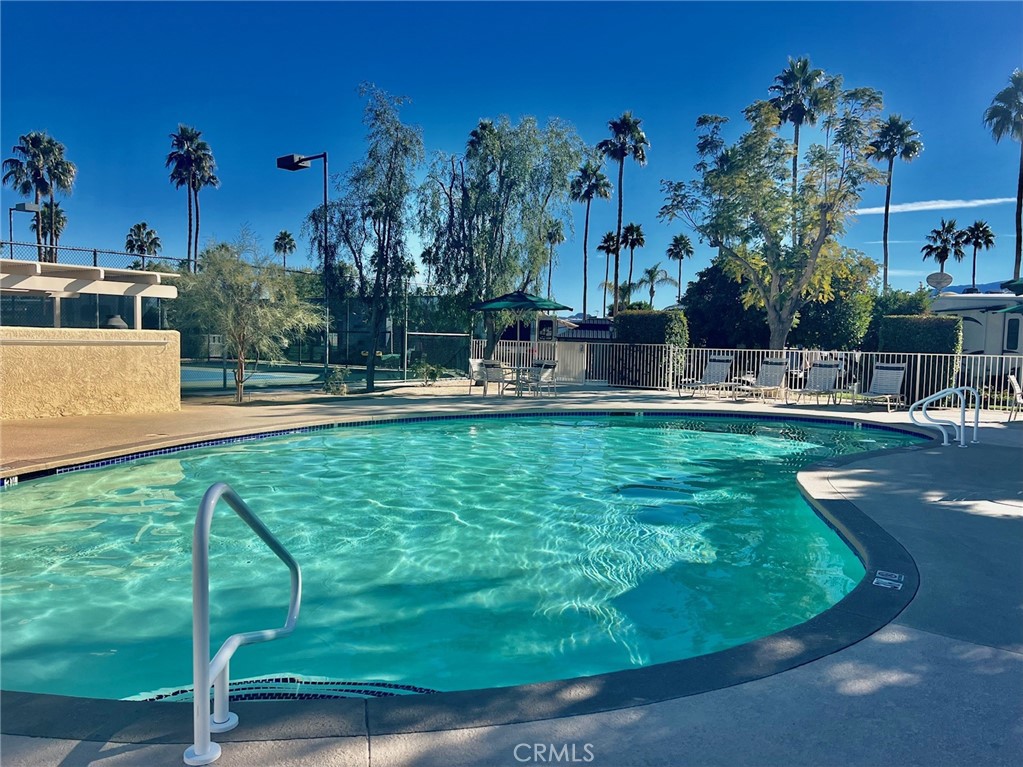 69411 Ramon Road, Unit 360 Cathedral City, CA 92234 - Photo 15 of 23 a view of a swimming pool with a yard