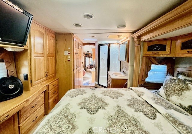 69411 Ramon Road, Unit 360 Cathedral City, CA 92234 - Photo 7 of 23 a bedroom with a bed and flat screen tv